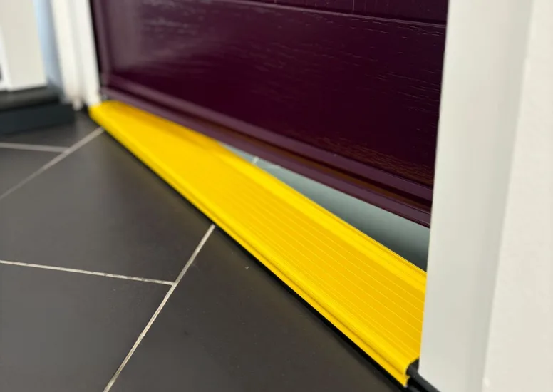 IG Doors sill protector fitted over a door sill on a construction site